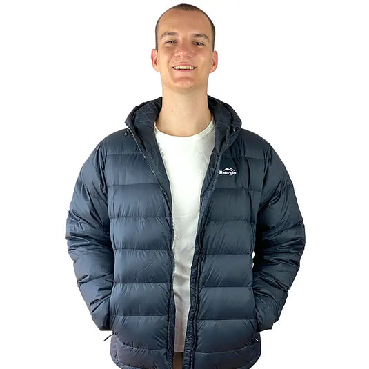 Man wearing Sherpa Men's Midweight 650+ Hooded Down Jacket with compact hood in dark blue.