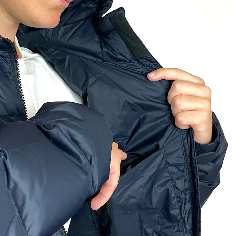 Load image into Gallery viewer, Man adjusting compact hood and showing inner pocket of Sherpa Men’s Midweight 650+ Hooded Down Jacket.