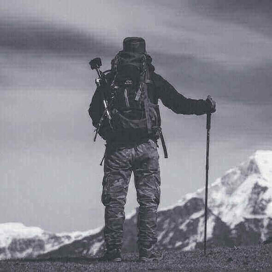 Hiker with full gear overlooking mountains in Australia, featuring essential adventure clothing and equipment for a 2023 hiking trip.