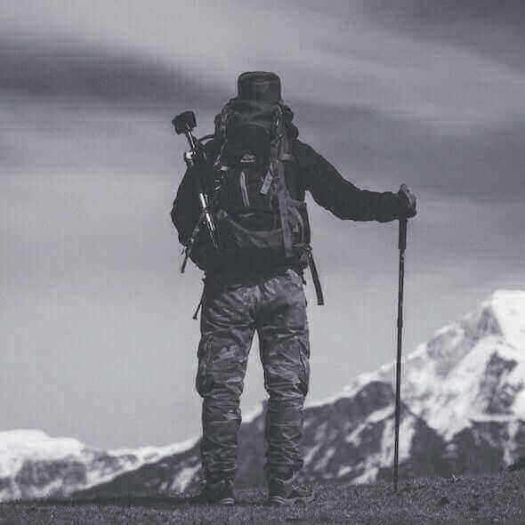 Hiker with full gear overlooking mountains in Australia, featuring essential adventure clothing and equipment for a 2023 hiking trip.