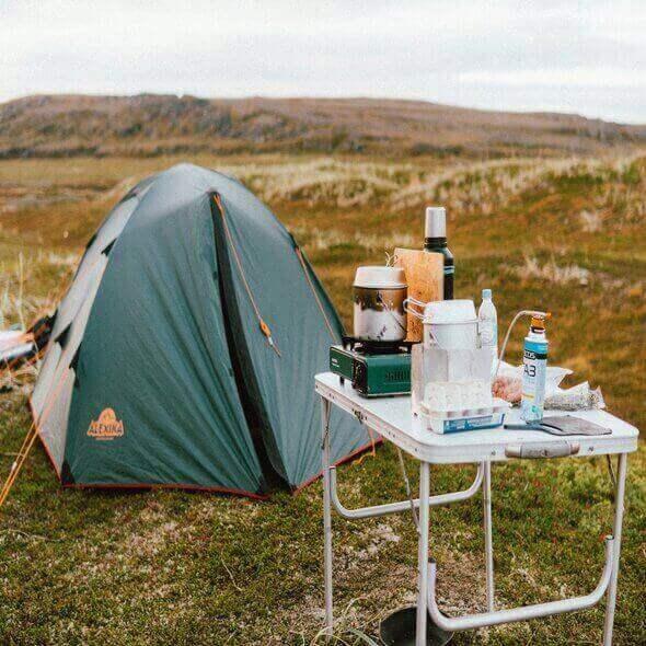 Camping tent and table with eco-friendly camping meals in an Australian outdoor setting