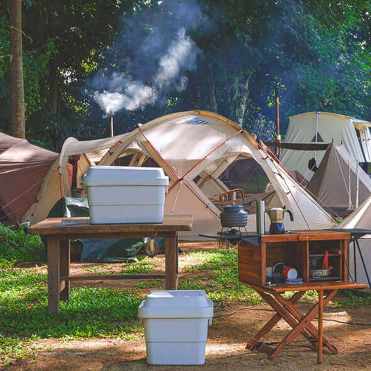 Sustainable camping setup with reusable containers, eco-friendly gear, and tents in a forested, zero-waste hiking and camping site.