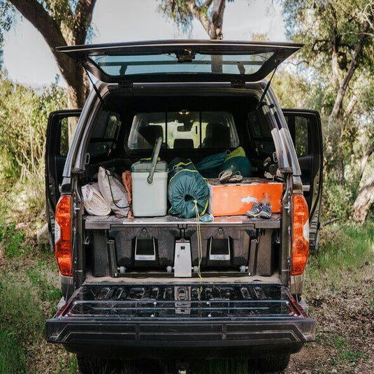 Camping gear packed in truck with biodegradable items for eco-friendly outdoor adventure.