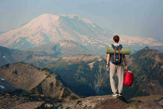 Hiker with gear looking at mountain view, practicing ways to avoid chafing while hiking - Adventureco Blog