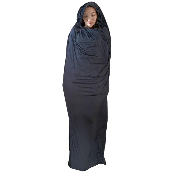 Person wrapped in Sherpa Thermolite Sleeping Bag Liner with hood for extra warmth. Ideal for camping, hiking, or traveling.