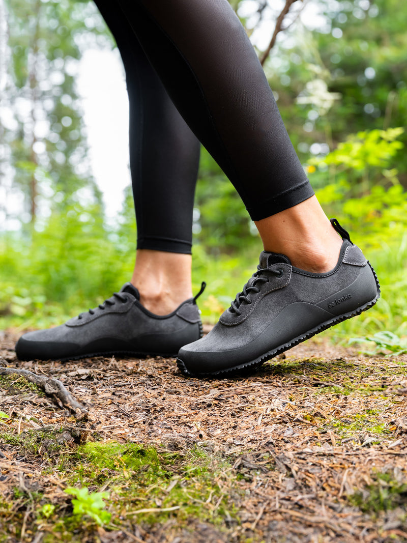 Load image into Gallery viewer, Close-up of Barefoot Shoes Be Lenka Trailwalker 3.0 in dark grey, worn on a forest trail for outdoor adventures.
