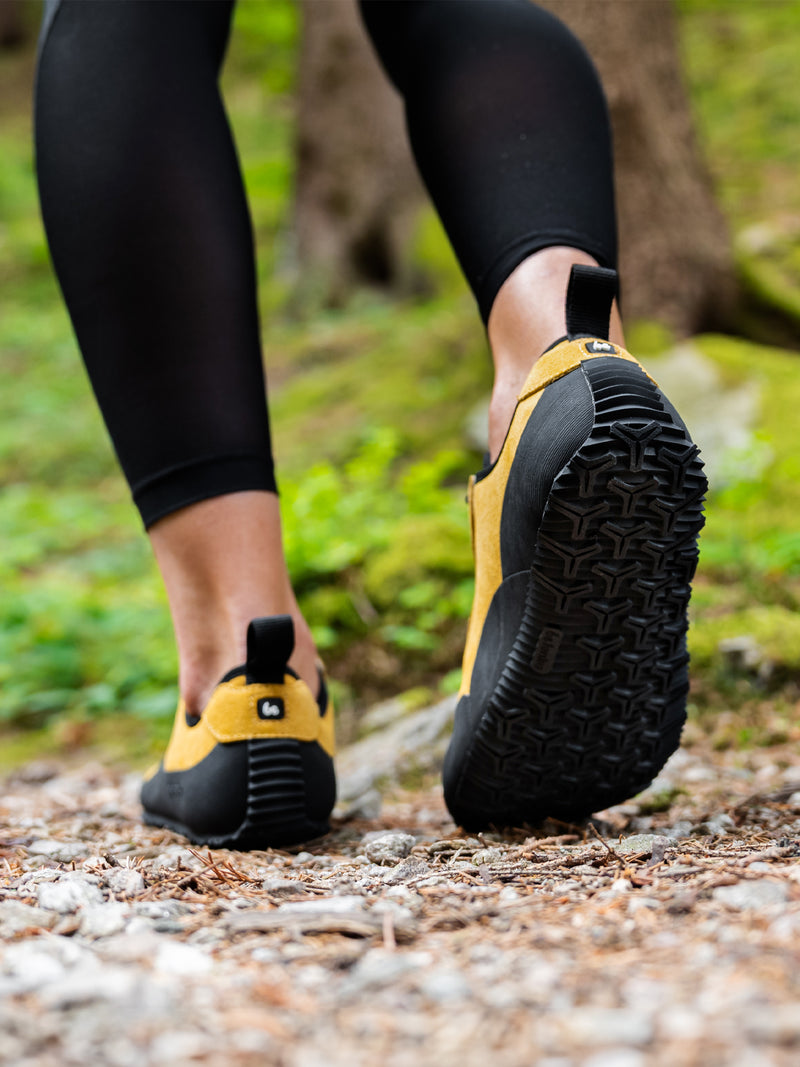 Load image into Gallery viewer, Barefoot shoes Be Lenka Trailwalker 3.0 in yellow, showcasing flexibility and TrailproGrip sole on a forest trail.
